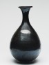 Black ware bottle with floral decoration (side)