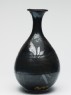 Black ware bottle with floral decoration (side)