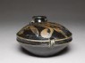 Black ware bottle with floral decoration (oblique)