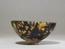 Black ware tea bowl with 'tortoiseshell' glazes (side)