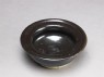 Black ware bowl with iron glaze (oblique)