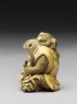 Netsuke in the form of a monkey holding a crab (side)