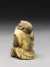 Netsuke in the form of a monkey holding a crab (side)