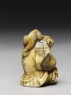 Netsuke in the form of a monkey holding a crab (side)