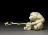 Okimono, or ornament, in the form of a monkey holding a branch (side)