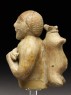 Figure of a musician carrying a water-skin (side)