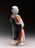 Figure of a man holding a fan (side)