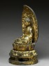 Figure of the Buddha with a mandorla, or halo, seated on a lotus pedestal (side)