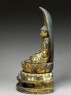 Figure of the Buddha with a mandorla, or halo, seated on a lotus pedestal (side)