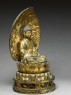 Figure of the Buddha with a mandorla, or halo, seated on a lotus pedestal (side)