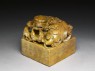 Soapstone seal surmounted by shishi, or lion dog, and seven pups (oblique)