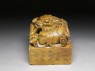 Soapstone seal surmounted by shishi, or lion dog, and seven pups (oblique)