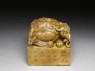 Soapstone seal surmounted by shishi, or lion dog, and seven pups (oblique)