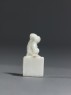 Porcelain seal surmounted by a seated animal (side)