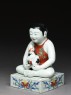 Figure of a boy seated on a shogi, or chess board (side)