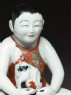 Figure of a boy seated on a shogi, or chess board (detail)