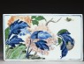 Blue-and-white tile with a landscape on one side and flowers on the other (back)