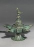 Oil lamp with dome-shaped lid surmounted by a bird (oblique)