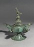 Oil lamp with dome-shaped lid surmounted by a bird (oblique)