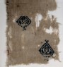 Textile fragment with diamond-shaped medallions containing a pseudo-kufic word (detail)