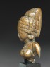 Female figure with a tall headress (side)