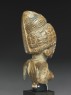 Female figure with a tall headress (side)