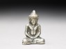 Silver amulet in the form of the Buddha (oblique)