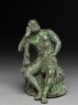 Figure of the hero god Heracles with his club seated on a lion (side)