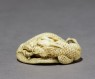 Netsuke in the form of a dragon coiled around a bowl (oblique)