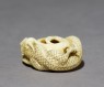 Netsuke in the form of a dragon coiled around a bowl (oblique)