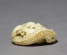 Netsuke in the form of a dragon coiled around a bowl (oblique)