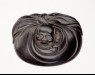 Manjū netsuke in the form of Hotei peering from his sack (oblique)