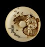 Manjū netsuke depicting Daikoku scattering coins for Ebisu (back)