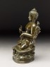 Seated figure of the Buddha with flowers, stupa, and bottle (side)