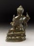 Seated figure of the Buddha with flowers, stupa, and bottle (side)