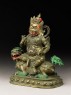 Figure of a male deity seated on a mythical animal, possibly a lion dog (side)