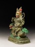 Figure of a male deity seated on a mythical animal, possibly a lion dog (side)