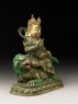 Figure of a male deity seated on a mythical animal, possibly a lion dog (side)