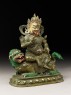 Figure of a male deity seated on a mythical animal, possibly a lion dog (side)