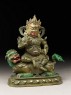 Figure of a male deity seated on a mythical animal, possibly a lion dog (side)