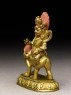 Figure of a male deity seated on a human-faced animal (side)