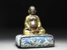 Figure of Hvashang seated on a cushion (side)