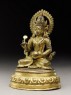 Seated figure of a deity holding a spoon and pot (side)