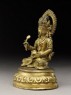 Seated figure of a deity holding a spoon and pot (side)