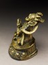 Seated figure of a male deity holding a bell and vajra, his head cocked back and mouth open, possibly an incense burner or pill dispenser (side)