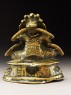 Seated figure of a male deity holding a bell and vajra, his head cocked back and mouth open, possibly an incense burner or pill dispenser (side)