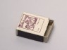 Matchbox depicting three figures holding tools (oblique)