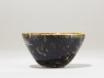 Black ware tea bowl with 'tortoiseshell' glazes (side)