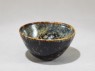 Black ware tea bowl with 'tortoiseshell' glazes (oblique)