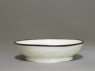 White ware bowl with dragons, flowers, and clouds (oblique)